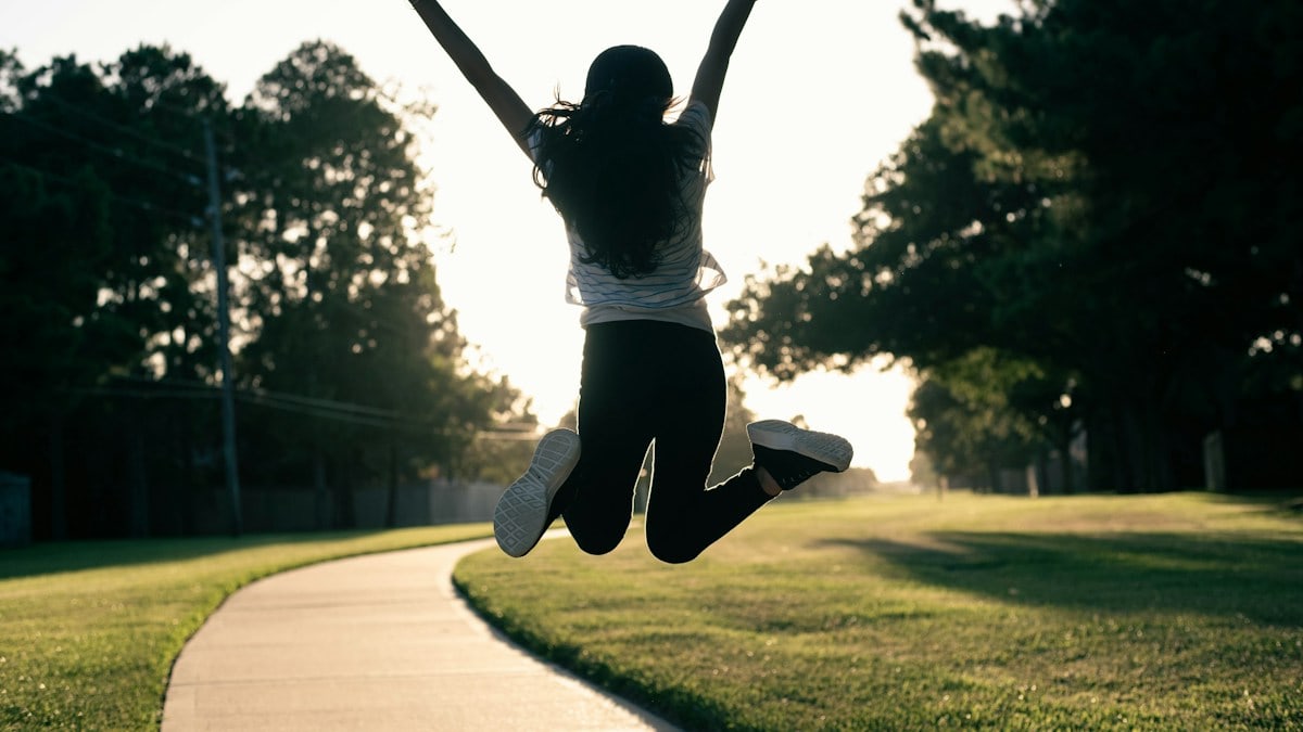 A person jumping in the air on a skateboard